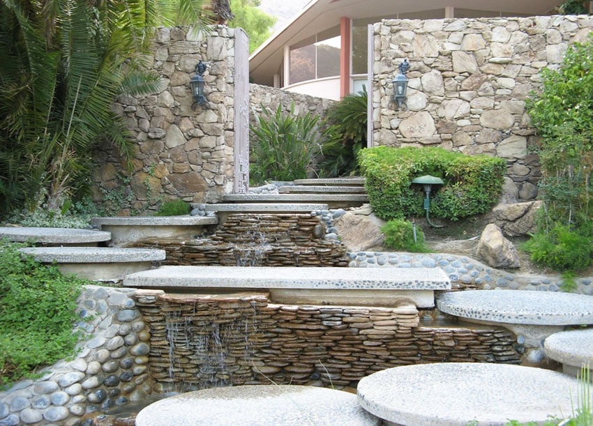 Natural stone wall and round pebbled steps