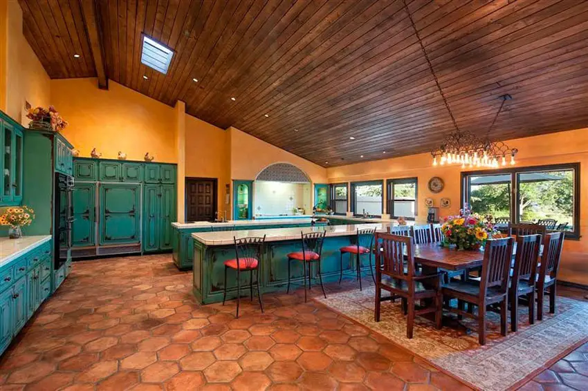 Kitchen with green cabinets, hexagonal tile flooring and beadboard ceiling