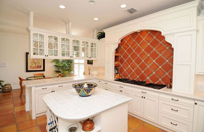 Spanish style white cabinet kitchen with brick back splash over range