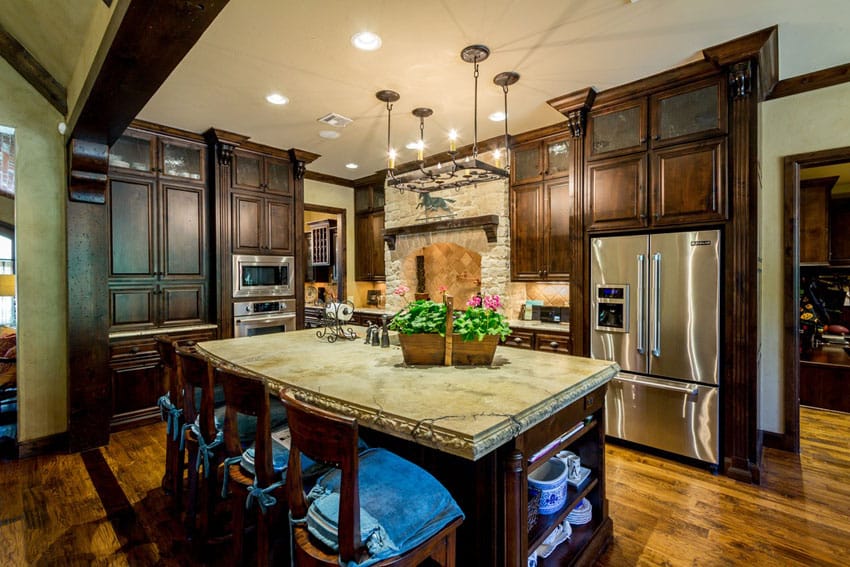 Traditional kitchen with hardwood floors dark cabinets and light stone counters
