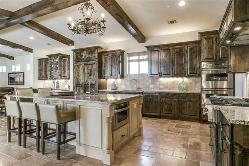 Traditional Mediterranean style kitchen with large island and exposed beam ceiling