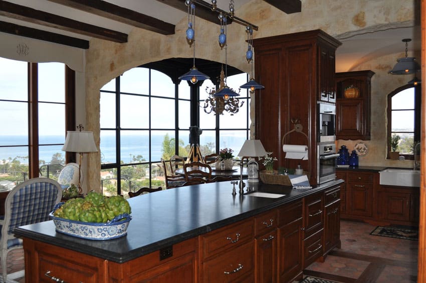 Traditional rustic kitchen with limestone counter, exposed beams and oceanview