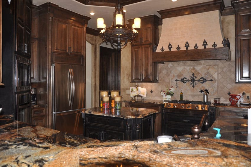 U shaped kitchen with desert dream granite counter and wrought iron chandelier
