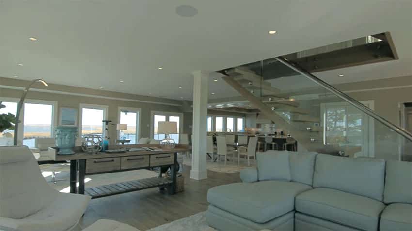 Open living room to dining area with wraparound water views