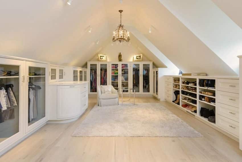 Walk in closet with arched ceiling crystal chandelier and European oak floors