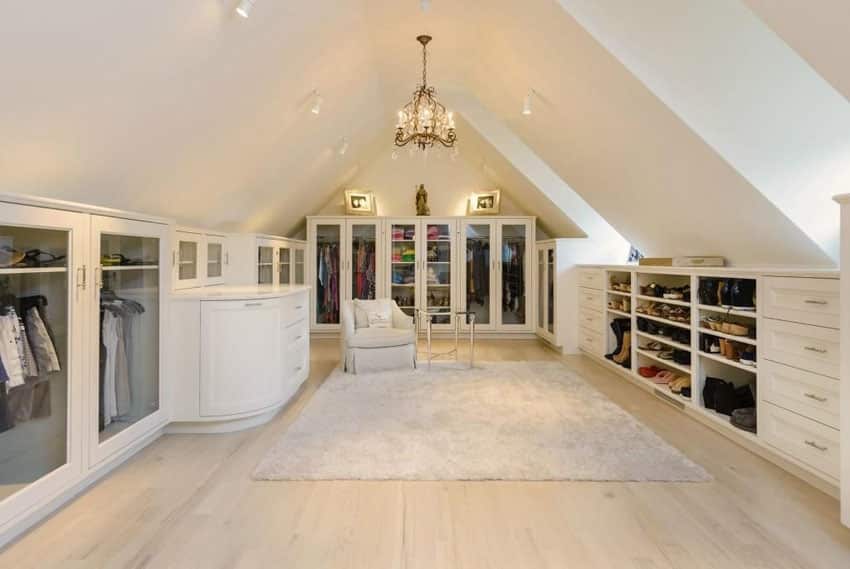 walk in closet with arched ceiling crystal chandelier and european oak floors