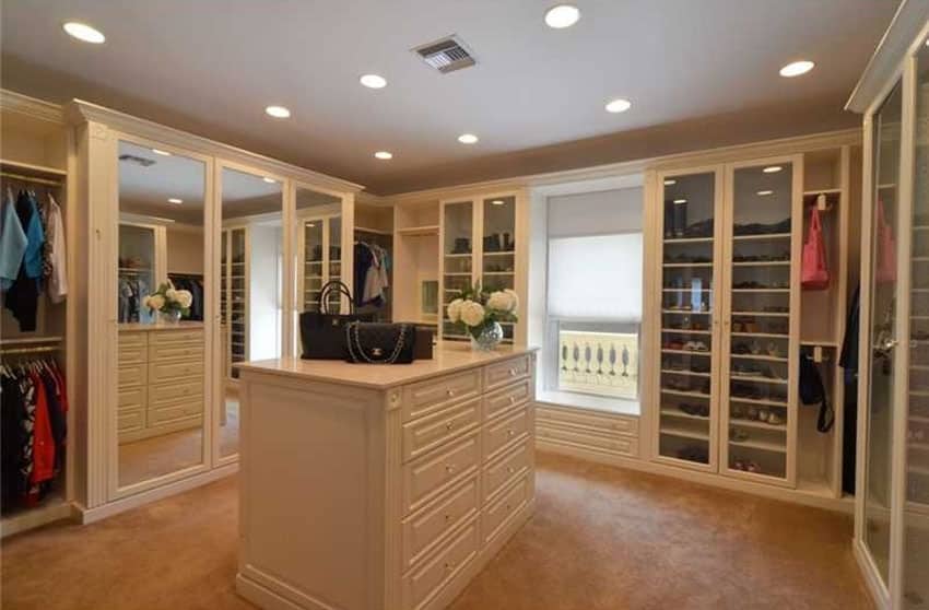 Closet with custom cabinetry, large mirror wardrobe ands recessed lighting