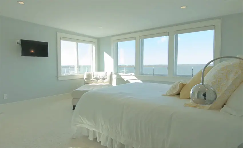 Waterfront view bedroom with light blue paint