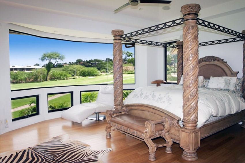Amazing view from bedroom with decorative post bed, wood slat floor and zebra rug