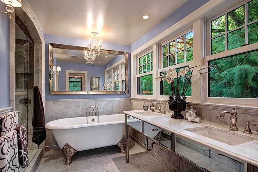 Bathroom with wide mirror, single hung windows and dark brown towel