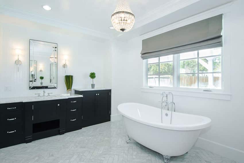 Bathroom with small chandelier and claw foot tub with silver feet