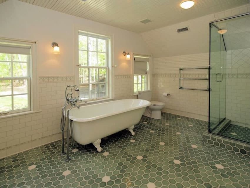Bathroom with vintage foot tub with green hexagon tiles on the floors