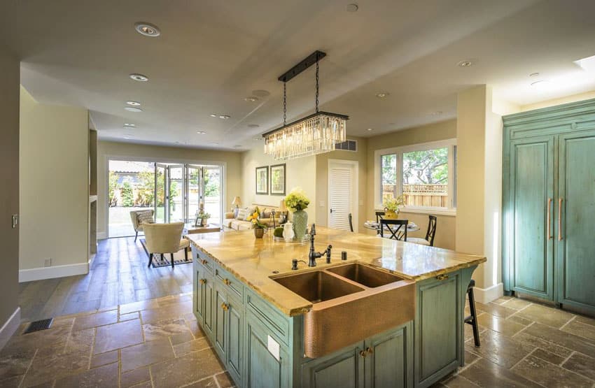 Beach style kitchen with green cabinets copper sink and rectangular chandelier