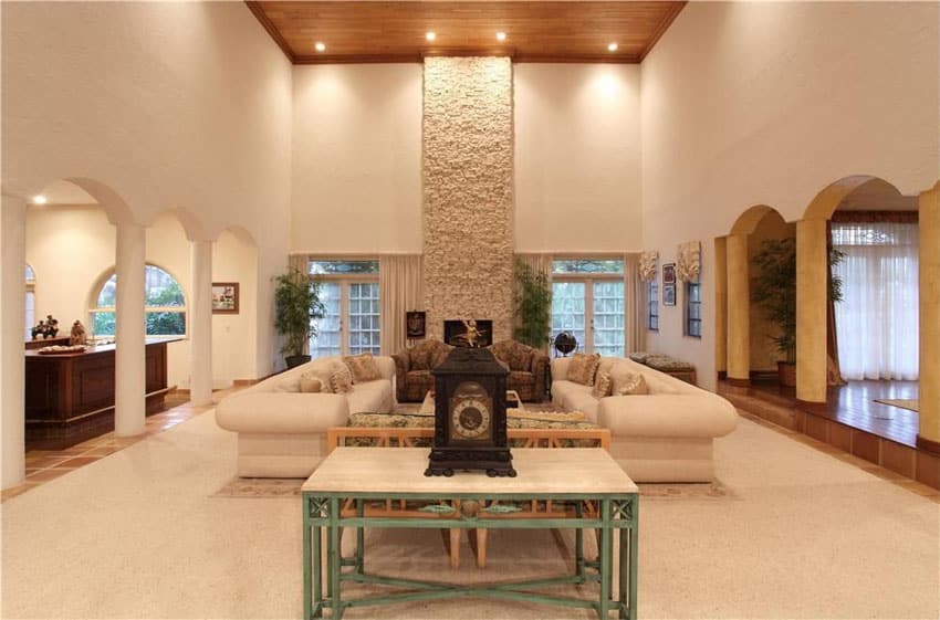 Beautiful living room with stone fireplace and high wood ceiling