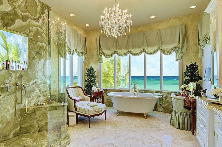 Beautiful bathroom with ocean view from bathtub and shower with chandelier
