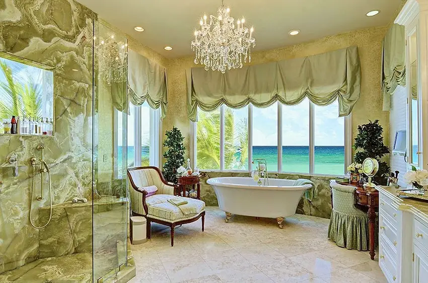 Bathroom with ocean view from bathtub and shower with chandelier