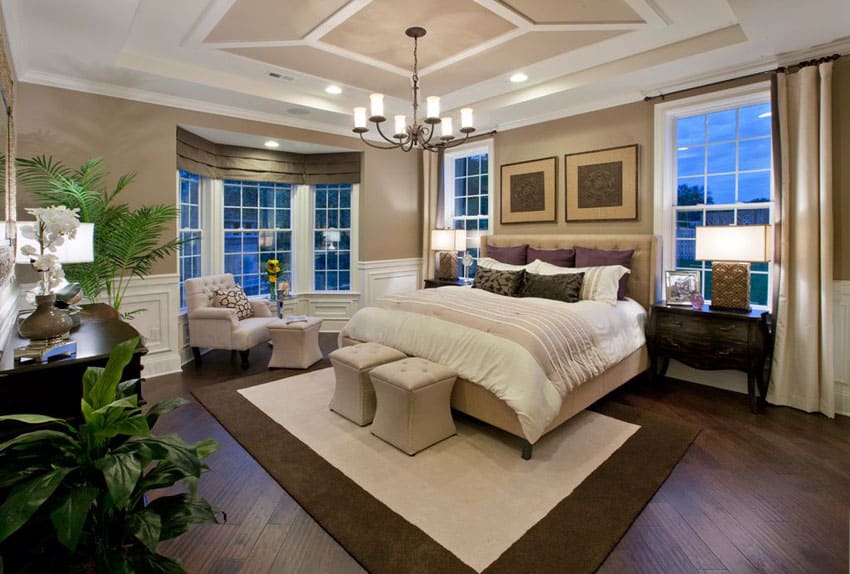 Beautiful master bedroom with window sitting area and rustic chandelier