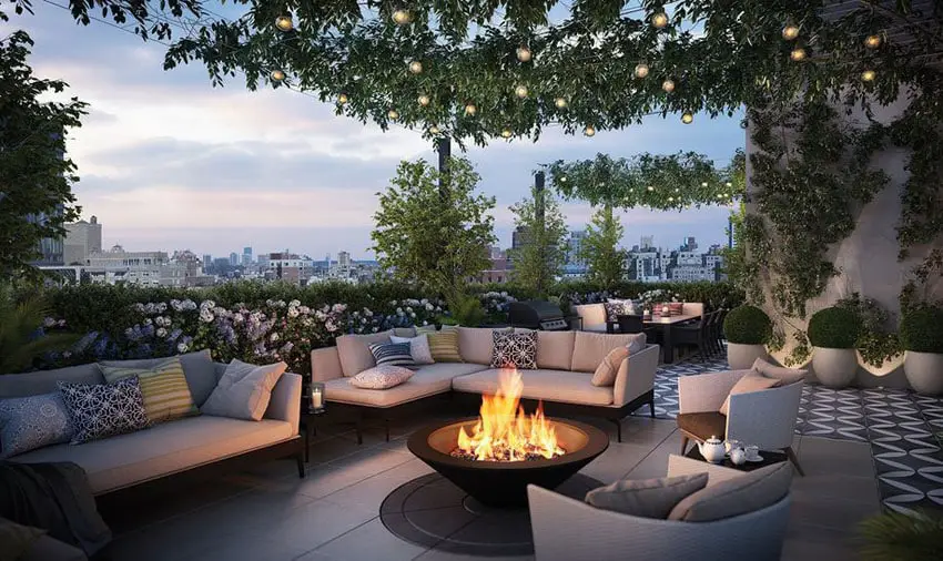 Beautiful rooftop patio area with landscaped plants and furniture