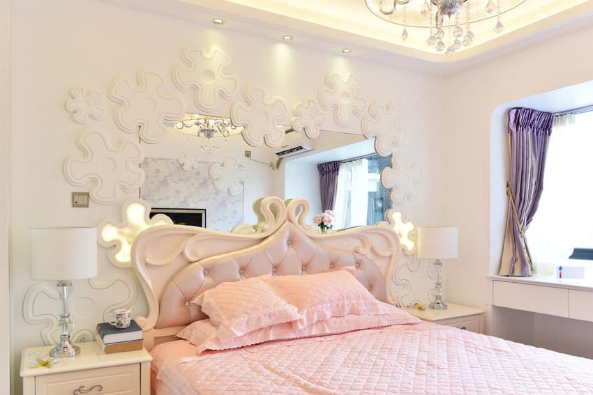 Beautifully decorated bedroom with pink bedding and white frame for bed