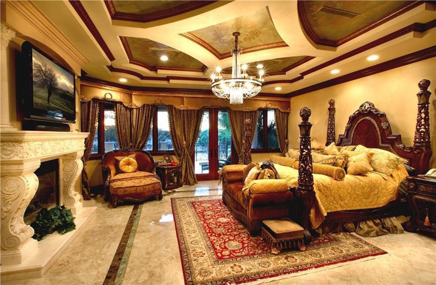 Beautifully decorated traditional master bedroom with stone fireplace and french doors
