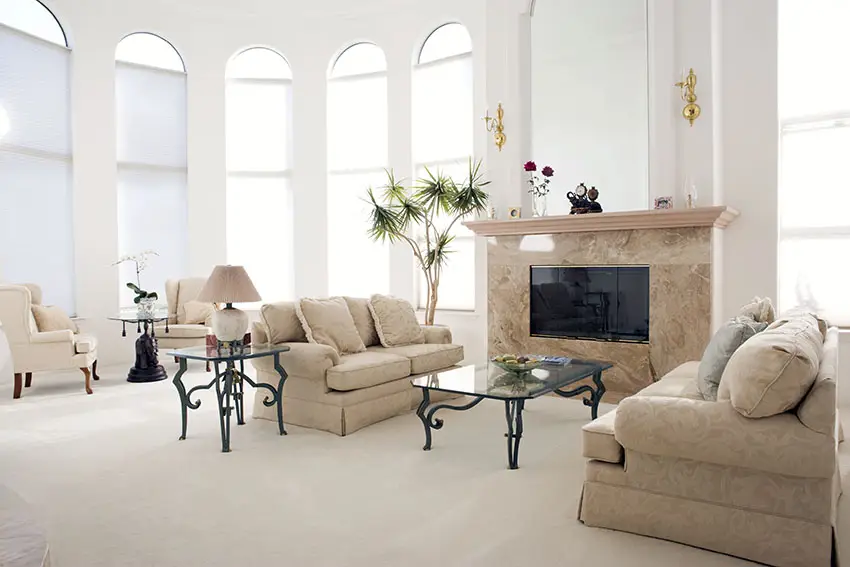 Tall arching winsows, polished marble walls and English loveseat sofas