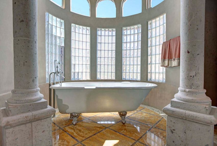 Cast iron clawfoot tub in luxury bathroom with pillars