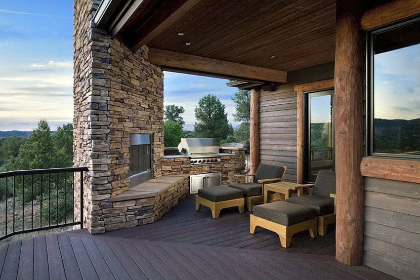 Composite deck under house with outdoor stone fireplace