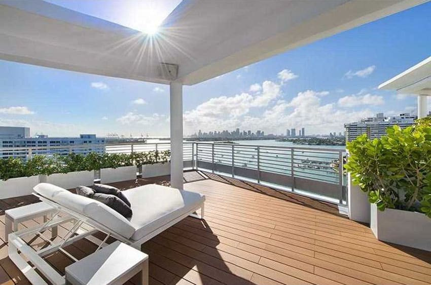 Composite deck with planters metal railings and view of bay