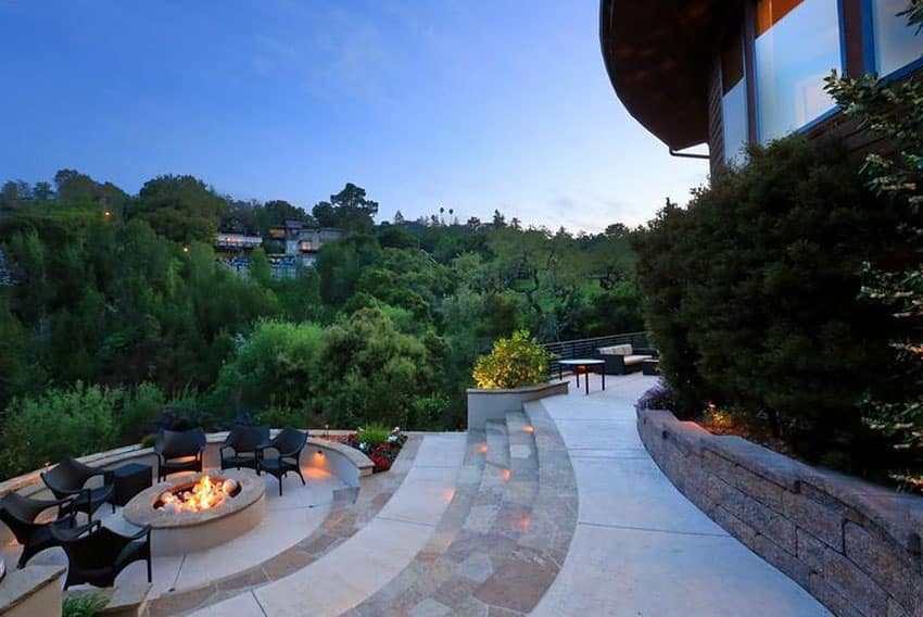 Concrete and stone patio with circular fire pit