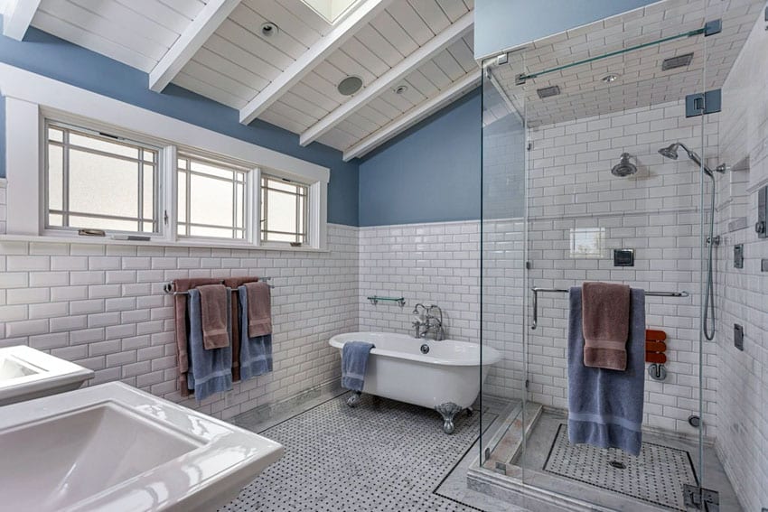 Bathroom with sloped ceiling, window, sink and brown and blue towel