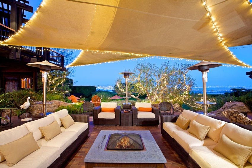 Contemporary brick patio with outdoor seating and canopy shade over fire pit
