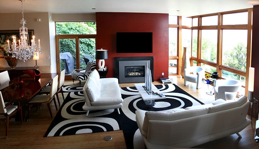 Contemporary casual living room with black and white decor and open floor plan next to dining area
