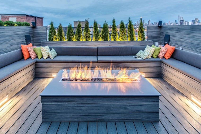 Contemporary deck with u shaped bench seating around modern gas fire pit