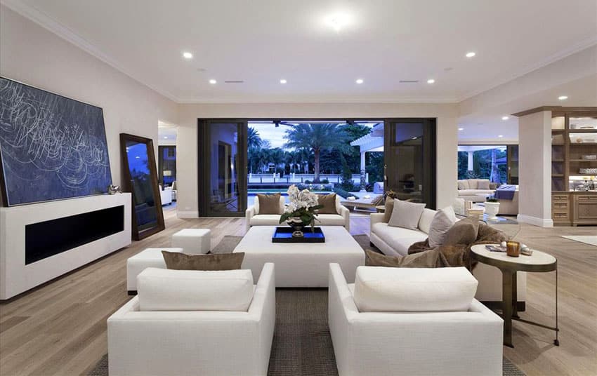 Contemporary formal living room with white furniture and retractable sliding door