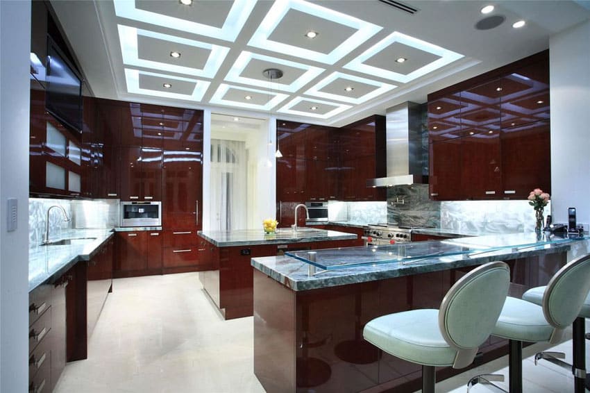 Kitchen with high sheen dark cabinetry and marble backsplash