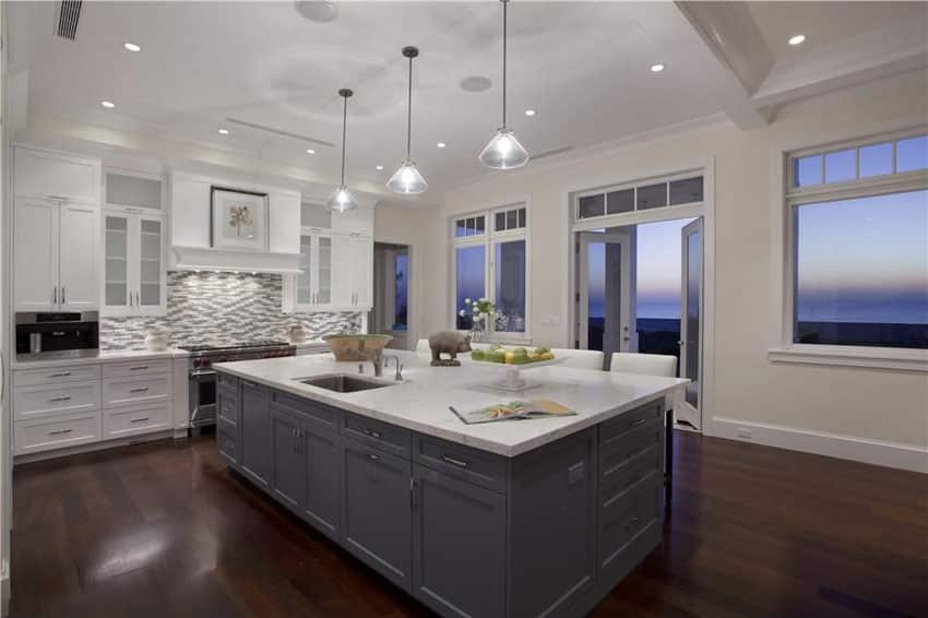 Contemporary kitchen with oceanview, tile backsplash and large island with cone shade pendant lights