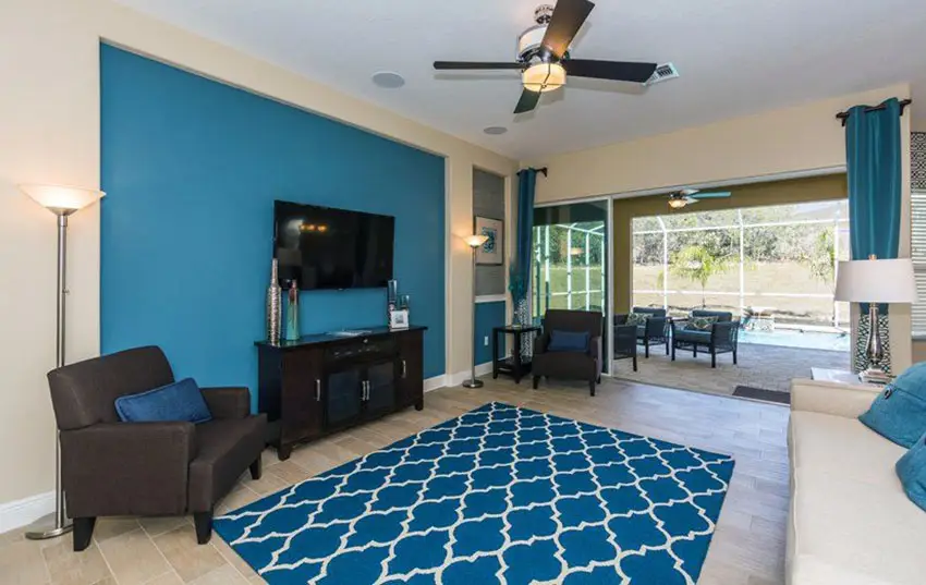 Contemporary living room with blue accent wall and blue curtains