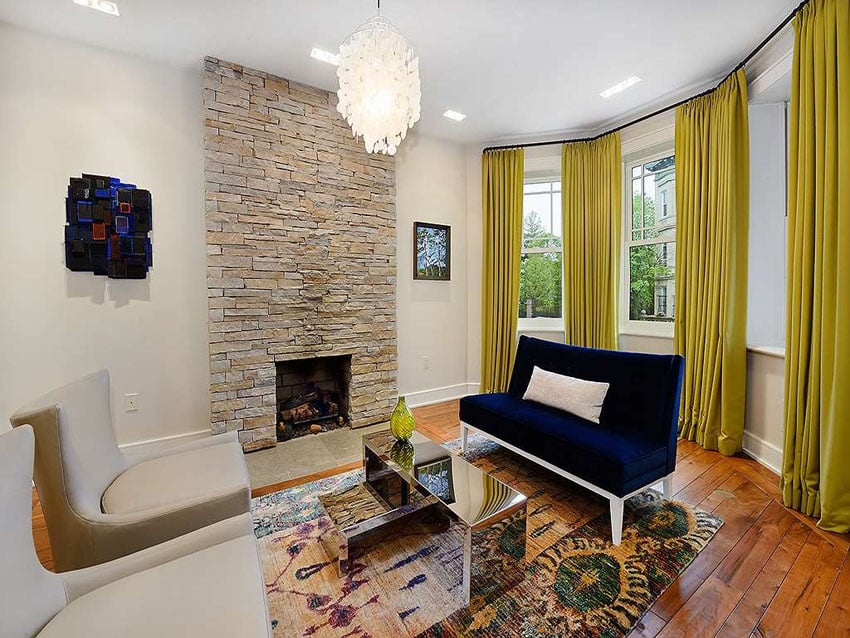 Contemporary living room with chandelier and stone fireplace