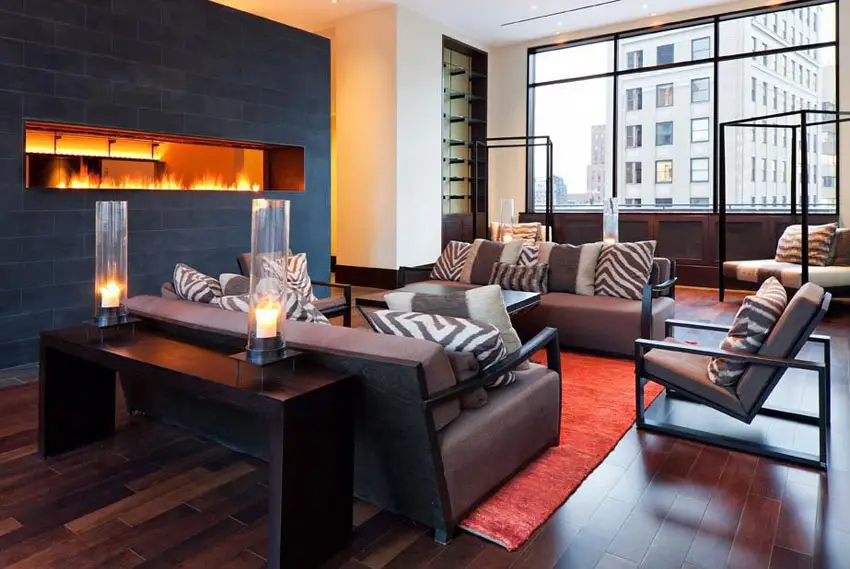 Room with black wall with gas fireplace, wood console table and upholstered sofa set