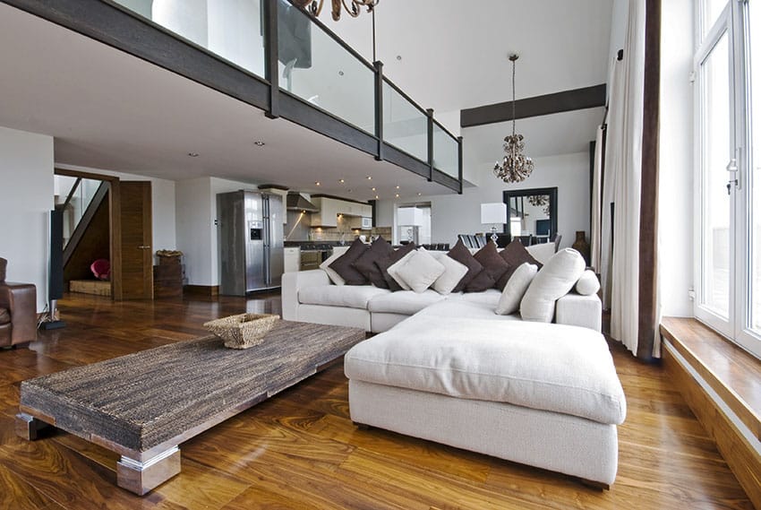 Contemporary living room with high ceilings and open balcony