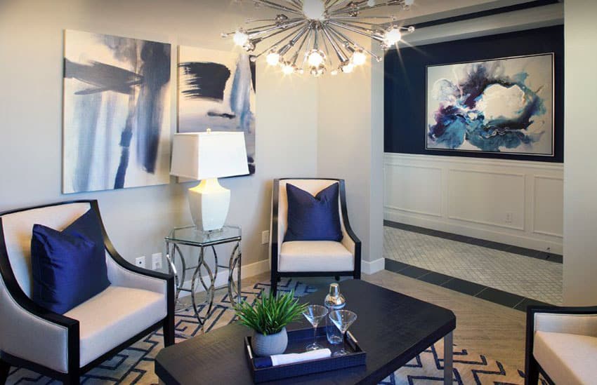 Contemporary living room with modern chandelier and navy blue accent wall