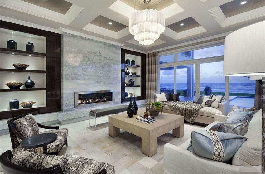 Room with marble slab walls, open shelving and crystal chandelier