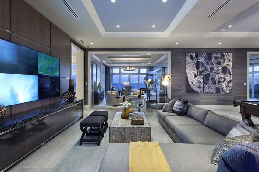 Contemporary living room with porcelain tile walls and gray sectional couch