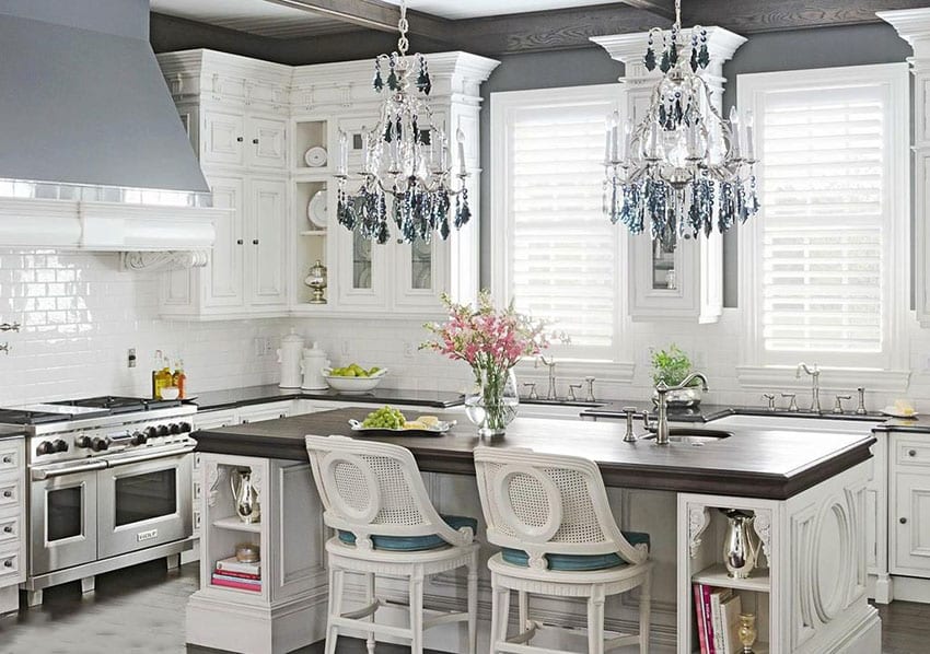Kitchen with hanging crystal chandeliers and breakfast bar island