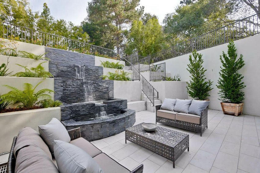 Contemporary luxury patio with stacked stone water fountain and outdoor furniture