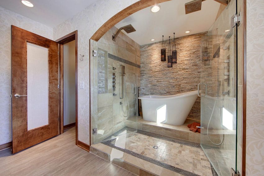 Contemporary master bathroom with bathtub in the shower with stacked stone accent wall