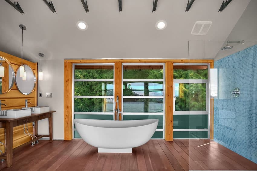 Contemporary master bathroom with gel coated bathtub and window views of trees