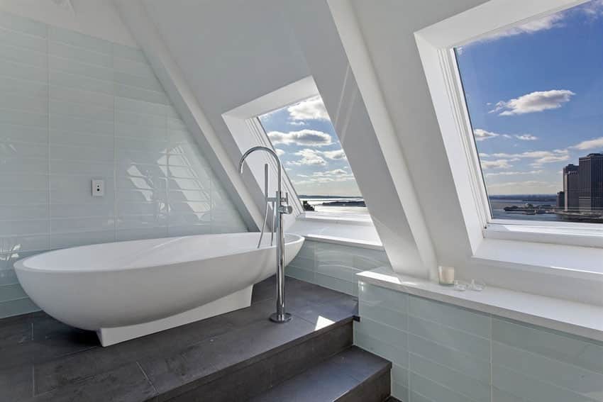 Contemporary master bathroom with pedestal bathtub and high city views