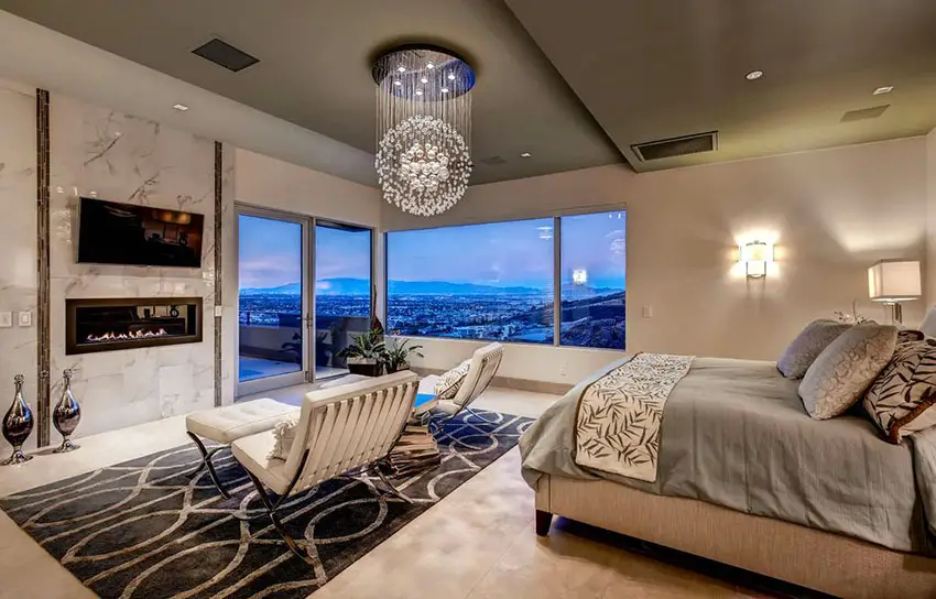 Contemporary master bedroom with modern globe chandelier, fireplace and amazing views