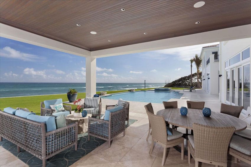 Contemporary ocean view patio next to swimming pool